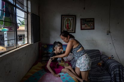 Marilú Peña takes care of her daughter Marely Hernández Peña, who suffers from ataxia. 