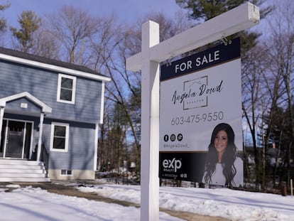 A "For Sale" sign is posted outside a single family home in Derry, New Hampshire.
