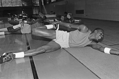 A young Michael Jordan (21 years old in this image from 1983) stretches during training.