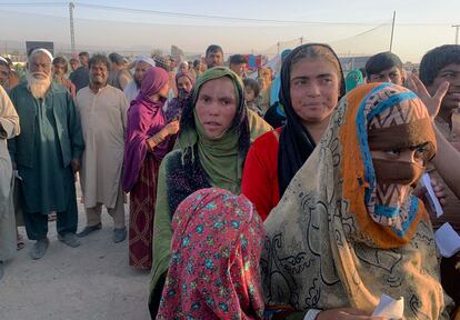 Familias afganas hacen cola para recibir alimentos de una ONG en las afueras de la ciudad paquistaní de Chaman, en la frontera con Afganistán, el 31 de agosto.