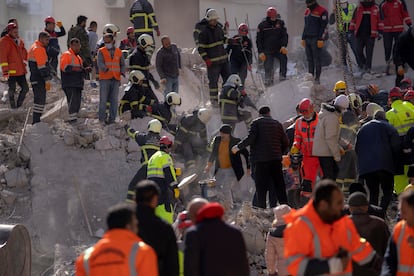 Firefighters and rescue teams search for people in a destroyed building, in Adana, southern Turkey, Wednesday, February 8, 2023.