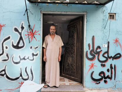 Hassan stands in front of the door of his house in the Fara'a refugee camp, which was blown up by Israeli soldiers.