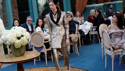 A model presents a creation with a Paris Cosmopolite theme by designer Karl Lagerfeld during the Metiers D&#8217;Art Show for Chanel fashion house in Paris