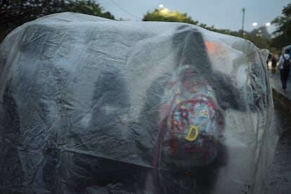 Los estudiantes a menudo utilizan plásticos y lonas que encuentran en su camino para cubrirse de la lluvia durante el tránsito por el puente que conecta las ciudades de Cúcuta, en el departamento del Norte de Santander (Colombia), y Ureña, en el Estado Táchira (Venezuela).