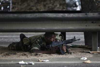 Un soldado leal al presidente electo Alassane Ouattara vigila una carretera en Abiyán.