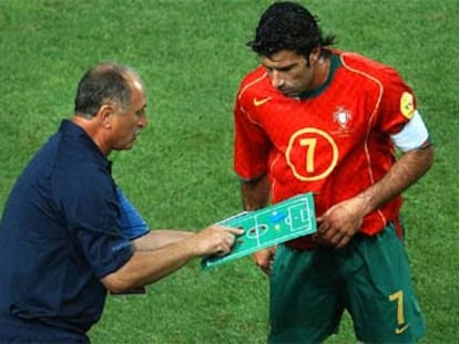 Figo atiende las indicaciones en la pizarra del seleccionador, Scolari, tras la realización de un cambio en Portugal.