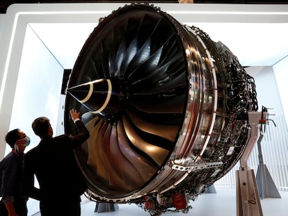 Dos personas miran un motor de Rolls-Royce que se muestra en el Salón Aeronáutico de Singapur, el 11 de febrero.