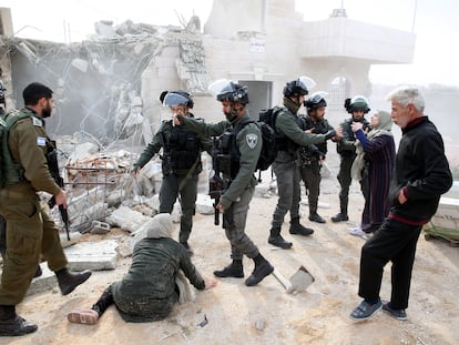 Mujeres palestinas imploran a soldados israelíes para evitar la demolición de su casa en construcción, el 28 de diciembre en Hebrón (Cisjordania).