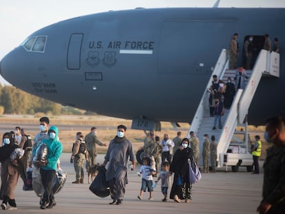 Evacuees from Afghanistan disembark from a U.S. airforce plane at the Naval Station in Rota, southern Spain, Tuesday Aug 31, 2021. The United States completed its withdrawal from Afghanistan late Monday, ending America's longest war. (AP Photo/ Marcos Moreno)