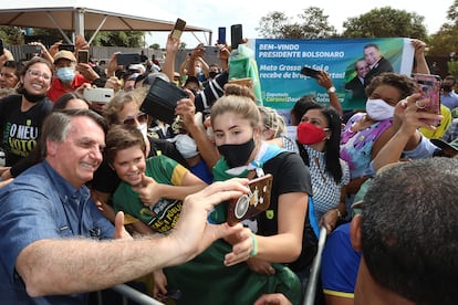 O presidente Jair Bolsonaro tira fotos com apoiadores em Terenos (MS), durante evento no dia 14.