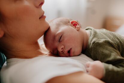 Mother putting her baby to sleep