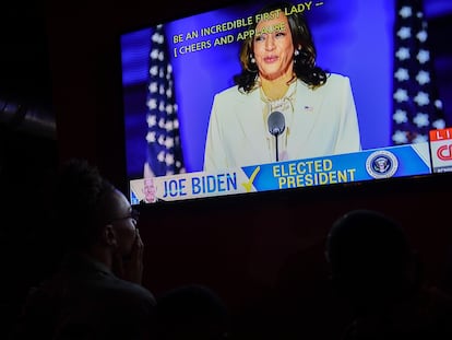 People watch Kamala Harris deliver a speech after being elected vice president of the United States.