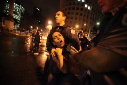 Un policía detiene a un manifestante que apoya la huelga de maestros del sector público el lunes 7 de octubre de 2013, en Río de Janeiro (Brasil). EFE/Archivo