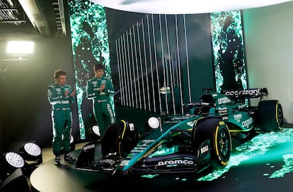 A handout picture released by Aston Martin shows the team's Formula 1 drivers Fernando Alonso (L) and Lance Stroll standing with the Aston Martin AMR23 Formula One racing car for the 2023 season, during its unveiling at their headquarters in Silverstone on February 13, 2023.