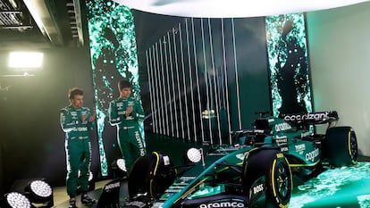 A handout picture released by Aston Martin shows the team's Formula 1 drivers Fernando Alonso (L) and Lance Stroll standing with the Aston Martin AMR23 Formula One racing car for the 2023 season, during its unveiling at their headquarters in Silverstone on February 13, 2023.