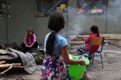 In this photo taken on Friday, Sept. 9, 2016, a woman cooks at Ritsona refugee camp north of Athens, which hosts about 600 refugees and migrants. Most of the people at the camp arrived in Greece in March, crossing to Lesbos and Chios just ahead of an agreement between the EU and Turkey that took effect. Under the deal, anyone arriving on Greek islands from Turkey on or after March 20 would be held on the island and face being returned to Turkey. Balkan countries began restricting crossings of their borders in early 2016, and shut them completely in early March, stranding tens of thousands of people in Greece. (AP Photo/Petros Giannakouris)