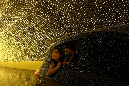 Dos niños miran las luces desde el interior de un vehículo mientras visitan Luminna Fest en São Paulo (Brasil), el 5 de diciembre.