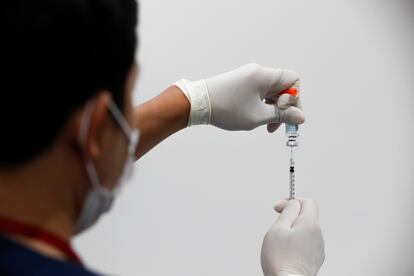 A health worker prepares a syringe containing the MPOX vaccine in Bangkok.