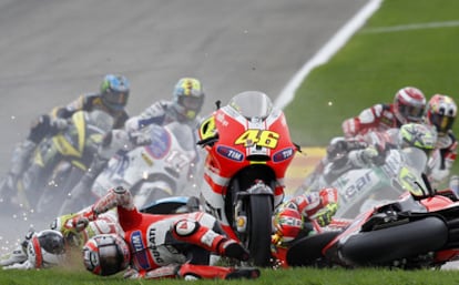 From left to right, Randy de Puniet, Nicky Hayden and Valentino Rossi hit the deck as Rossi's bike rolls on.