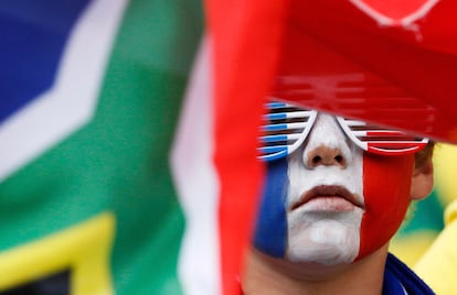 Un seguidor francés, con la cara pintada, entre banderas de Sudáfrica.