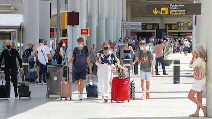 Tourists arrive at Palma de Mallorca airport on July 1.