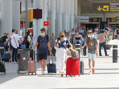 Tourists arrive at Palma de Mallorca airport on July 1.