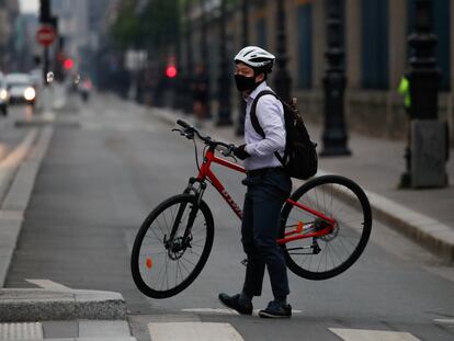 Un ciclista carga con su bicicleta en la calle Rivoli de París, en una imagen de mayo de 2020.