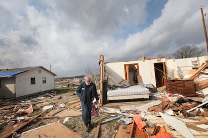 Keith Huke pasa frente a los restos de su dormitorio, en el que asegura que se refugi&oacute;  mientras el tornado arrasaba Harrisburg (Illinois). 