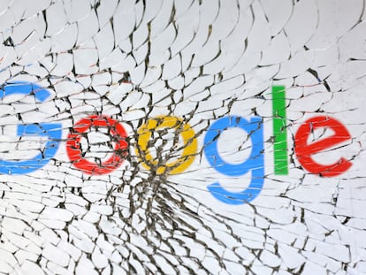 El logo de Google se ve a través de un montón de vidrios rotos.
