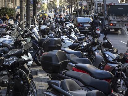 Nombroses motos aparcades en la vorera del carrer Diputació.