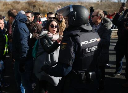 Agentes antidisturbios se enfrentan a los taxistas durante el corte de la M-40. El epicentro de la protesta ha estado en el recinto ferial Ifema, donde comenzaba Fitur, que ha sido inaugurada por los Reyes.