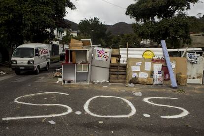 A vehicle passes by a barricade at a street eastern Caracas, Venezuela on Wednesday.