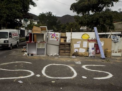 A vehicle passes by a barricade at a street eastern Caracas, Venezuela on Wednesday.