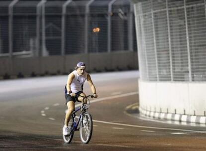 Fernando Alonso reconoce en bicicleta el circuito del GP de Singapur.
