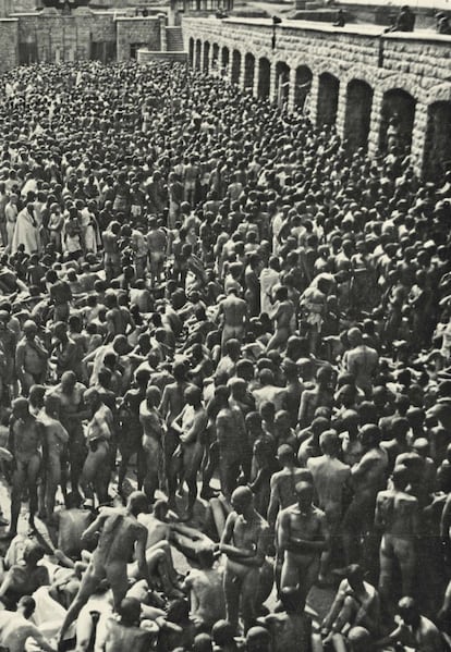 Hundreds of naked prisoners awaiting general disinfection at Mauthausen, June 21, 1941.