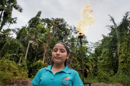 Dannya Bravo, next to a gas flare in La Joya de los Sachas, Orellana province, on August 26, 2024.