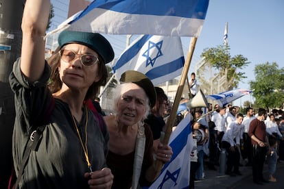 Mothers wearing Israel Defense Forces berets protest against a military conscription bill exempting ultra-Orthodox Jews, on May 4, 2023, in Jerusalem. 