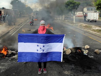 Un manifestante posa con la bandera hondure&ntilde;a hoy en Tegucigalpa 