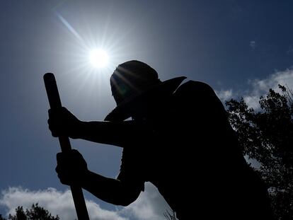 Carlos Rodriguez digs fence post holes Tuesday, June 27, 2023, in Houston.