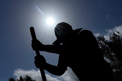 Carlos Rodriguez digs fence post holes Tuesday, June 27, 2023, in Houston.