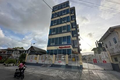 A man passes by Exxon Mobil Corp.'s headquarters in Georgetown, Guyana, June 29, 2023