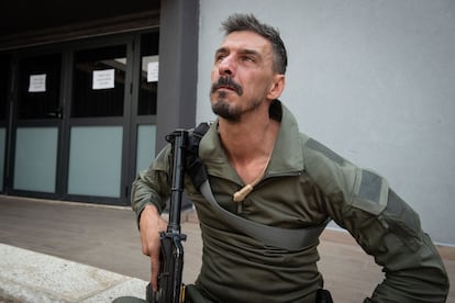 Reservist Amir Shamir, 43, guards the Kyriat Shmona civic center, where the evacuation is being organized.