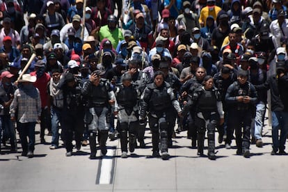 Elementos de las fuerzas de seguridad retenidos por los manifestantes caminan al frente de la movilización, este 10 de julio en Chilpancingo (Estado de Guerrero).