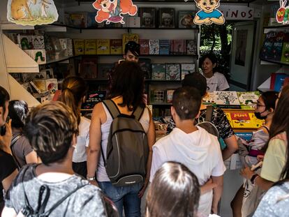 Varios jóvenes visitan una caseta de la Feria del Libro de Madrid en junio de 2022.