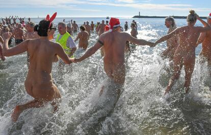 Pessoas participam do tradicional mergulho em comemoração ao Ano Novo na praia nudista Le Cap d'Agde, sul da França.