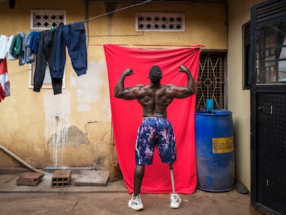 KAMPALA, UGANDA - Tamale Safalu trains in front of his home in Kampala, Uganda. Since he was little, he wanted to become a body builder. He succeeded but got a terrible motorcycle accident, causing him to loose one of his legs. Despite losing his leg, Tamale did not give up on body building. He now competes against able bodied people. He became the first athlete ever in Africa to compete against abled bodied athletes.