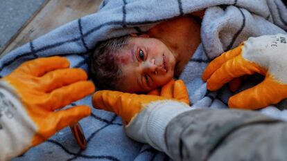 Rescuers hold baby boy Kerem Agirtas, a 20-day-old survivor who was pulled from under the rubble, in the aftermath of a deadly earthquake in Hatay, Turkey, February 8, 2023.