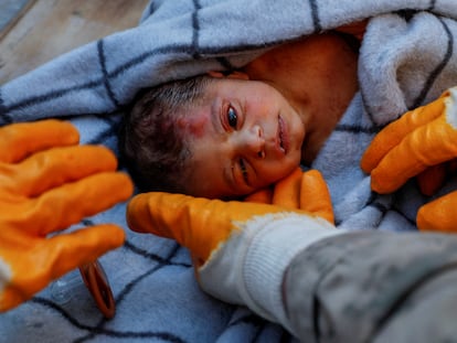 Rescuers hold baby boy Kerem Agirtas, a 20-day-old survivor who was pulled from under the rubble, in the aftermath of a deadly earthquake in Hatay, Turkey, February 8, 2023.