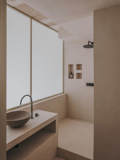 El cuarto de baño, también principalmente de cemento, tiene un lavabo de ICONICO.