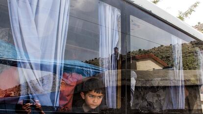 Un niño sirio mira por la ventana de un autobús que evacua a refugiados de la localidad de Shebaa (Líbano) para que puedan volver a sus hogares a las afueras de Damasco.